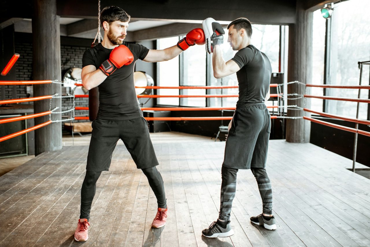 boxing-trainer-with-a-man-boxing-at-the-gym-2.jpg